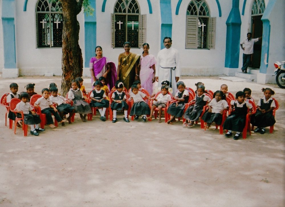 The Chennai Colony Preschool children are sitting in the chairs in India.