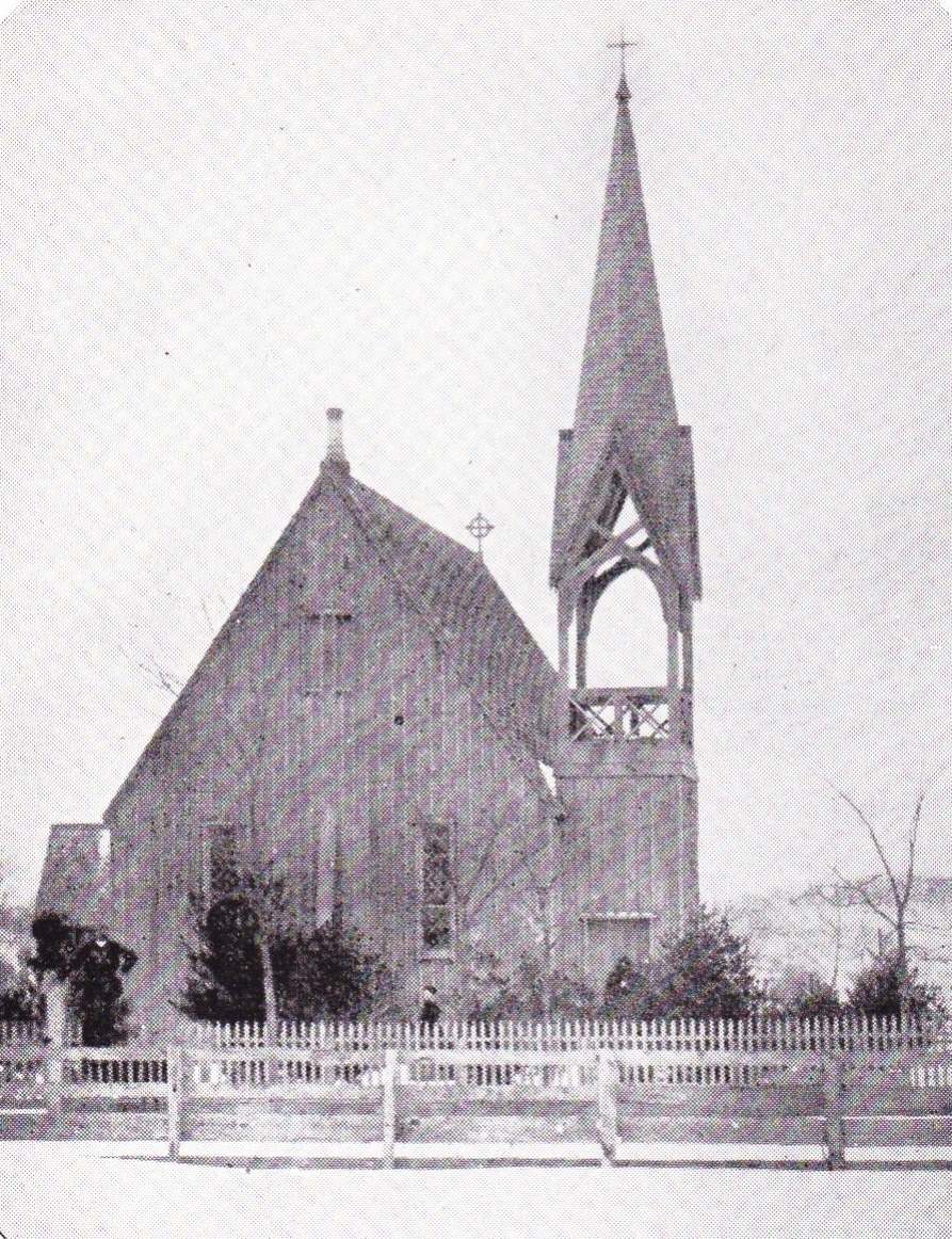 This early photograph of the Church of the Regeneration cannot now be dated with precision, but it certainly was taken some time after 1861, when the fence in the foreground was erected, and before 1879 when Theron Wilber, who has been identified as the individual standing with his hand on one of the fence posts, died. Since the young trees about the church seem well developed, it is probable that the photo was taken in the late 1860s or early 1870s. Note that the main entrance to the church then faced the west instead of the south, as at present, and that the belfry is vacant. It was this old photograph, owned by Mrs. E. Matthew Netter, from which the cover illustration derives.